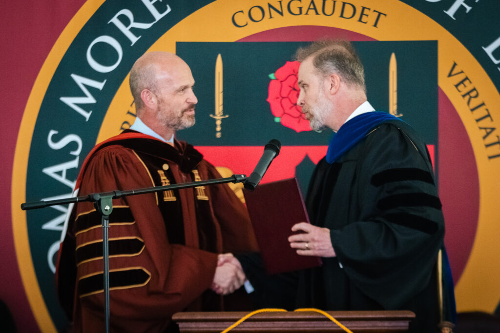 Kevin Roberts, president of the Heritage Foundation, receives an honorary doctorate from Thomas More College of Liberal Arts.