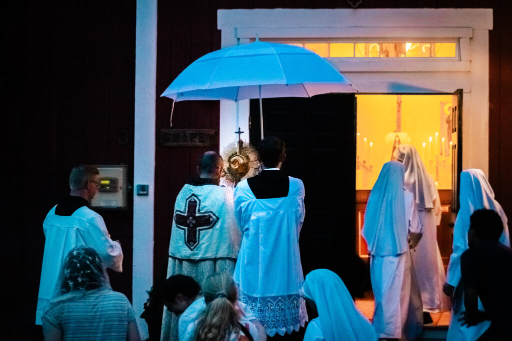 The Eucharistic procession enters the Thomas More College chapel.